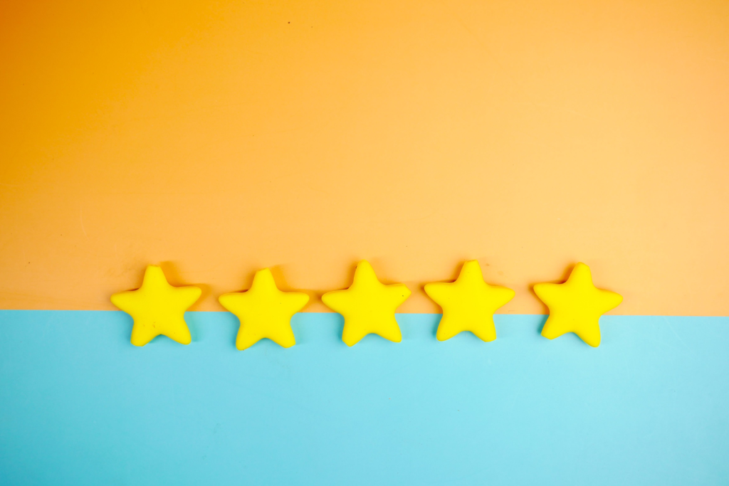 Bright yellow stars arranged on a vivid orange and blue background with copy space.